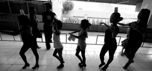 The dancers are made to walk with cups on their heads to improve posture and balance outside the Cebu City Dancesports Studio. A large portion of their practice time is devoted to maintaining correct posture and balance.